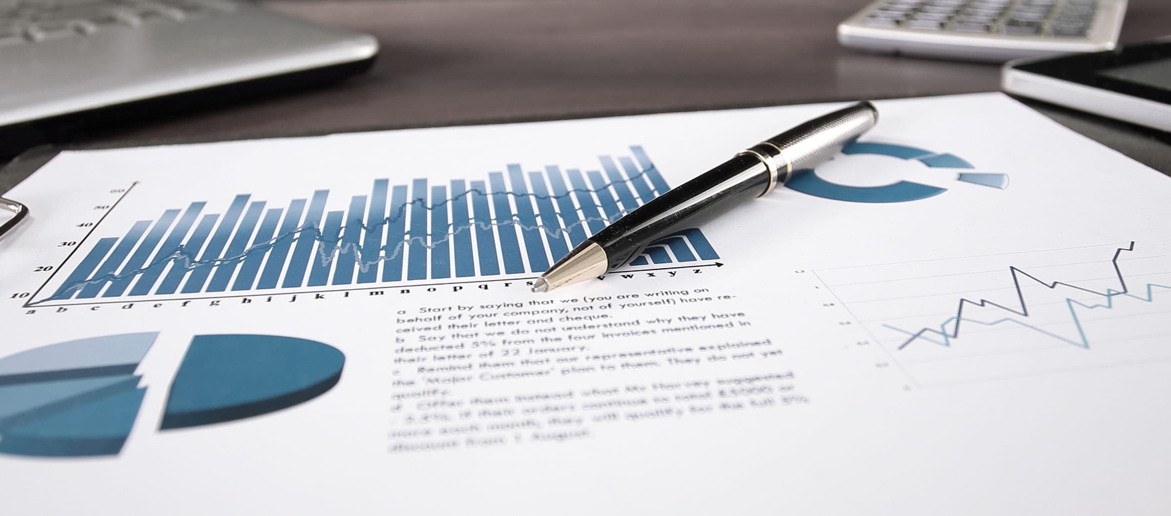Printed financial charts and a budget report on a desk